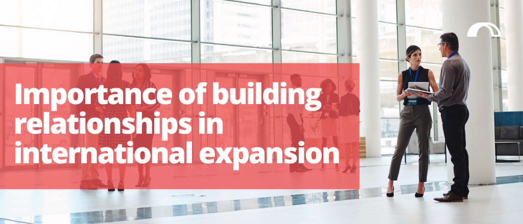 Blog title "Importance of building relationships in international expansion" with a background image of business people networking